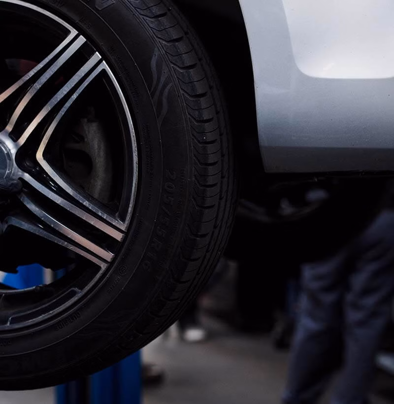 Achterwiel van auto op brug tijdens onderhoud bij Miji Autoservice Lelystad